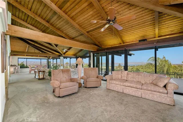 a living room with furniture and a book shelf