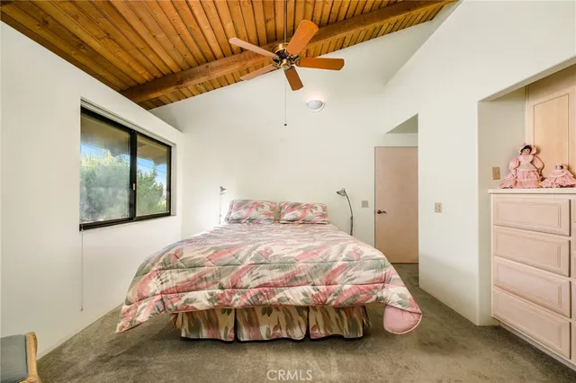 a bedroom with a large bed and a window