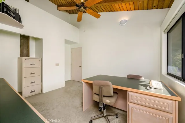 a view of a dining room with furniture a chandelier and wooden floor