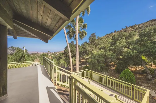 a large living room with stainless steel appliances kitchen island granite countertop furniture and a large window