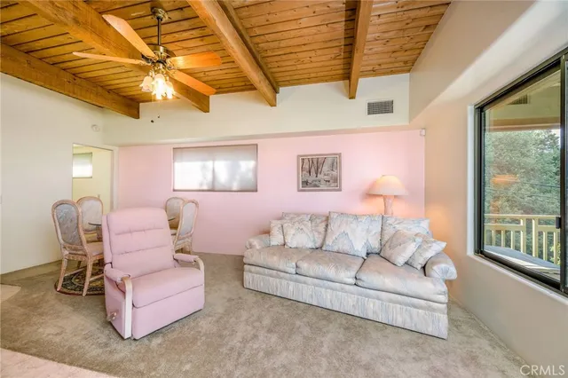 a front view of a house with a yard and potted plants