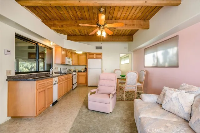 an aerial view of a house with swimming pool and a yard