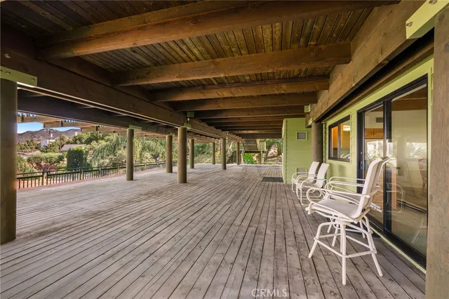 a front view of a house with a yard and mountain view