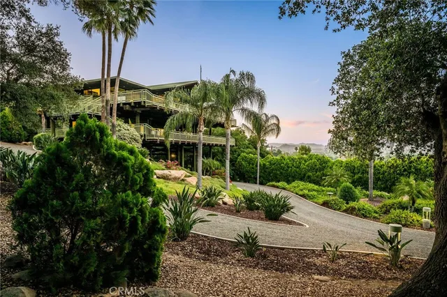 a view of a building with a large window and sitting area