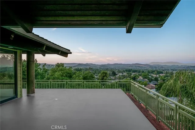 a dining room with furniture and a floor to ceiling window