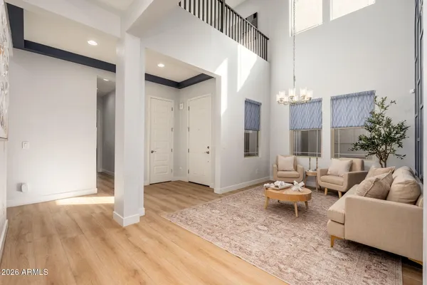 a kitchen with stainless steel appliances granite countertop a stove a refrigerator a oven a sink a dining table and chairs with wooden floor