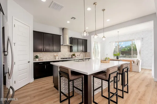 a kitchen with stainless steel appliances a sink a stove and a refrigerator