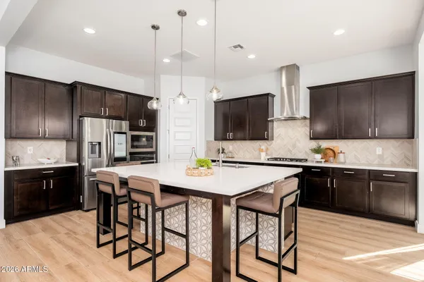 a kitchen with a sink and a stove with wooden floor