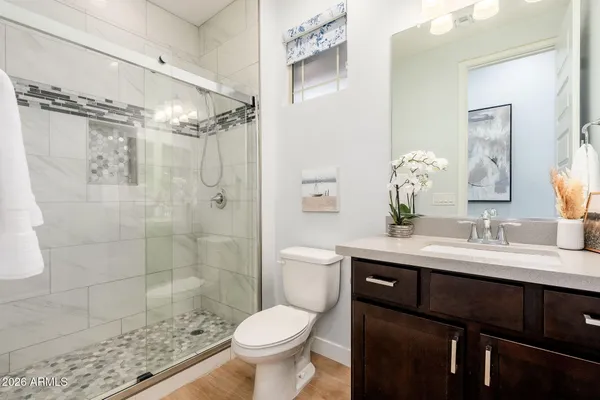 a living room with furniture a flat screen tv and a window