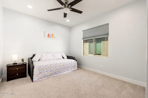 a bedroom with a bed and ceiling fan