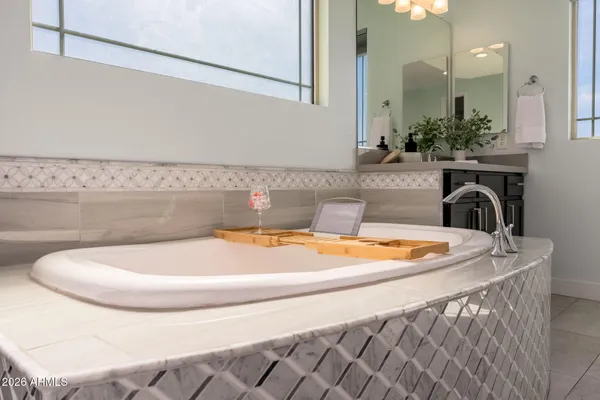 a living room with furniture a flat screen tv and kitchen view