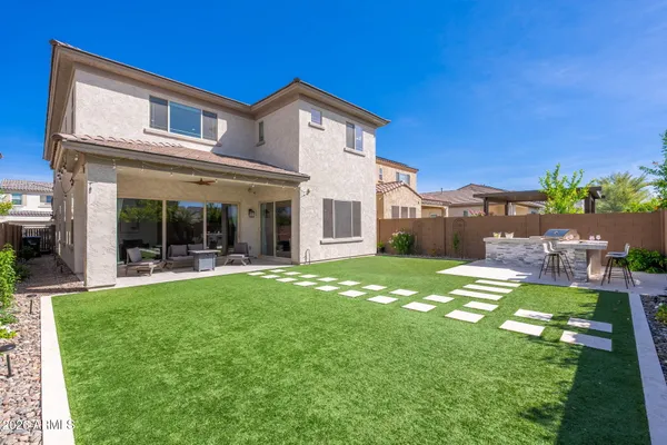 a view of a big yard with a table and chairs