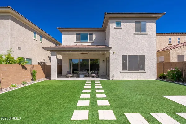a view of a patio with a table chairs and a swimming pool