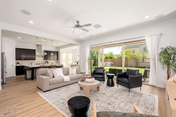a view of a livingroom with furniture wooden floor and staircase