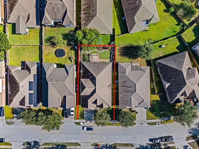 an aerial view of a house with a yard