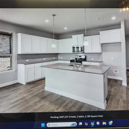 a kitchen with a sink stainless steel appliances and cabinets