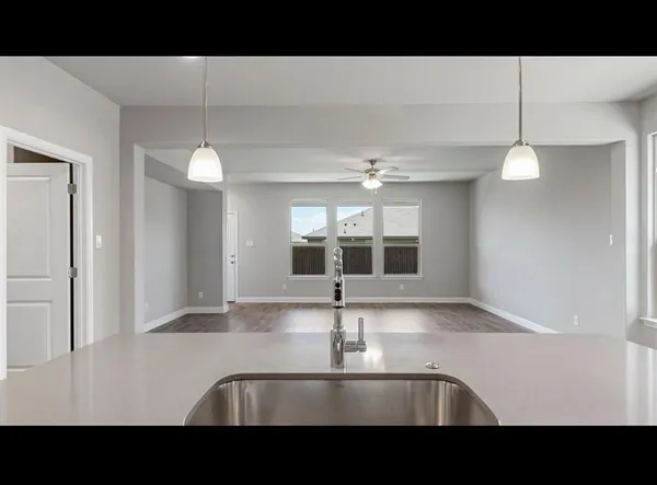 a view of a kitchen with a sink and a mirror