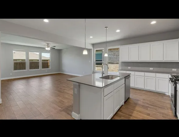 a kitchen with a sink window and cabinets