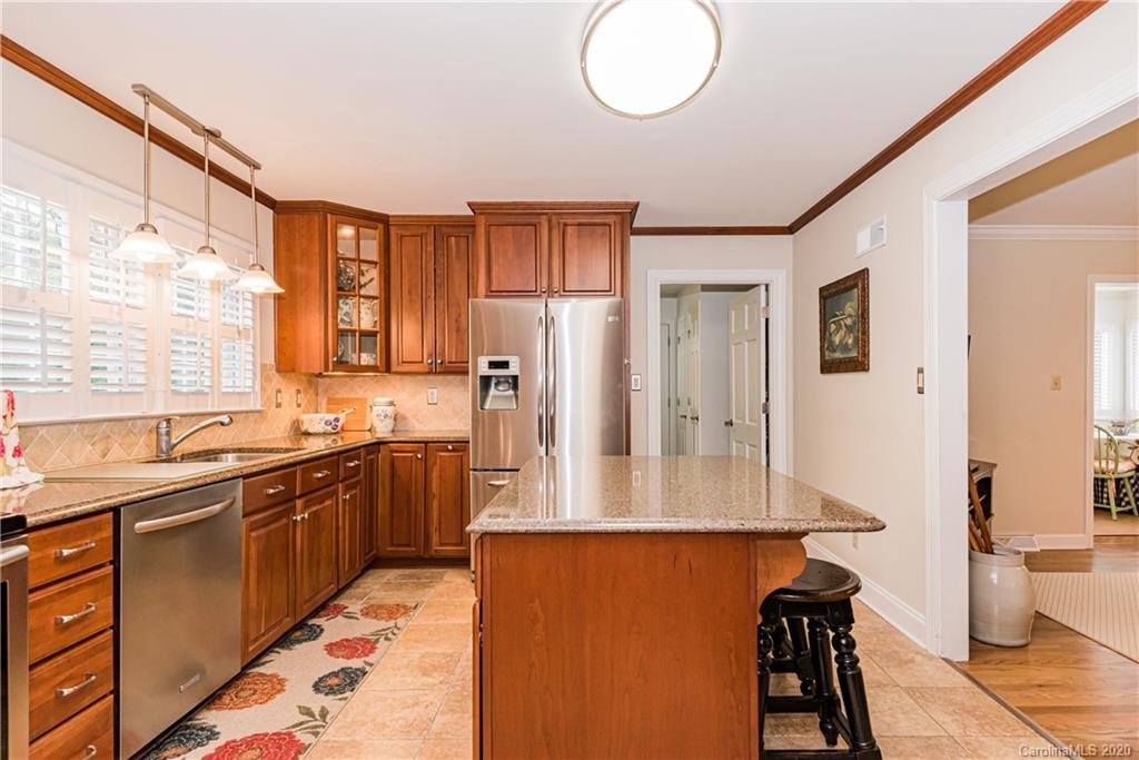 1001 Lansdowne Road Charlotte, NC 28270 - Photo 11 of 37 a kitchen with stainless steel appliances granite countertop a refrigerator and a stove top oven