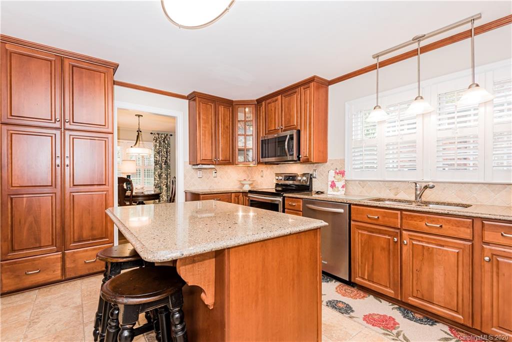 1001 Lansdowne Road Charlotte, NC 28270 - Photo 14 of 37 a kitchen with granite countertop a sink cabinets and window