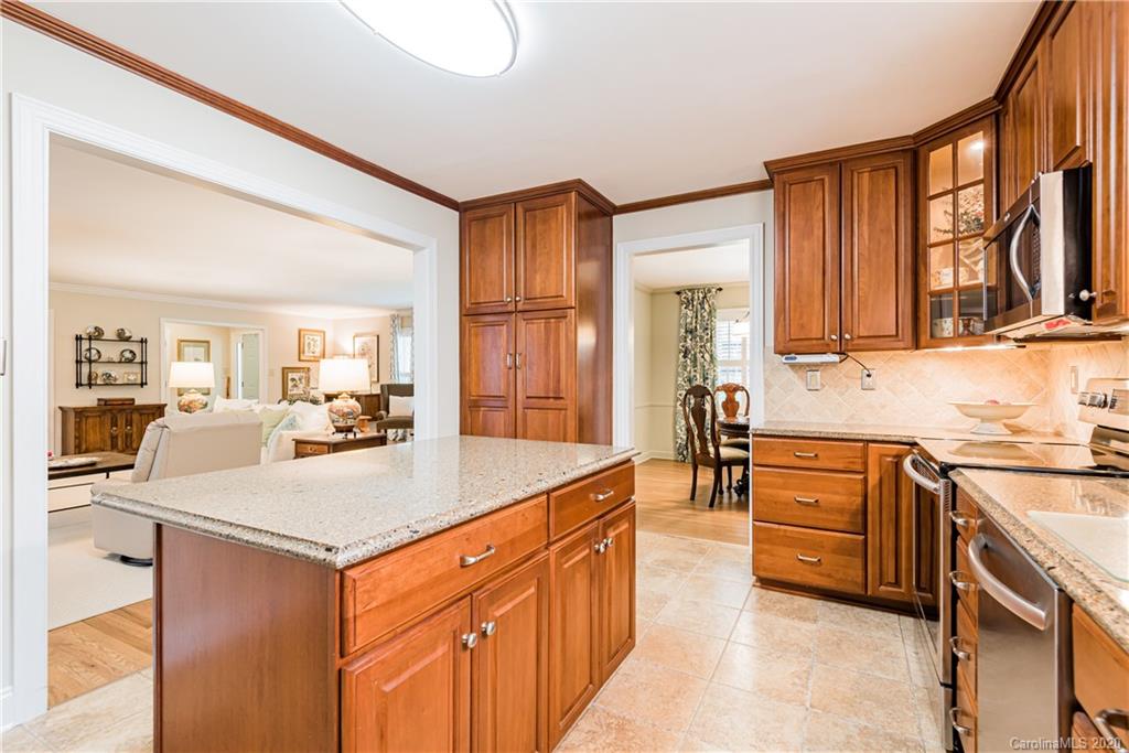 1001 Lansdowne Road Charlotte, NC 28270 - Photo 15 of 37 a kitchen with stainless steel appliances granite countertop a sink stove and cabinets