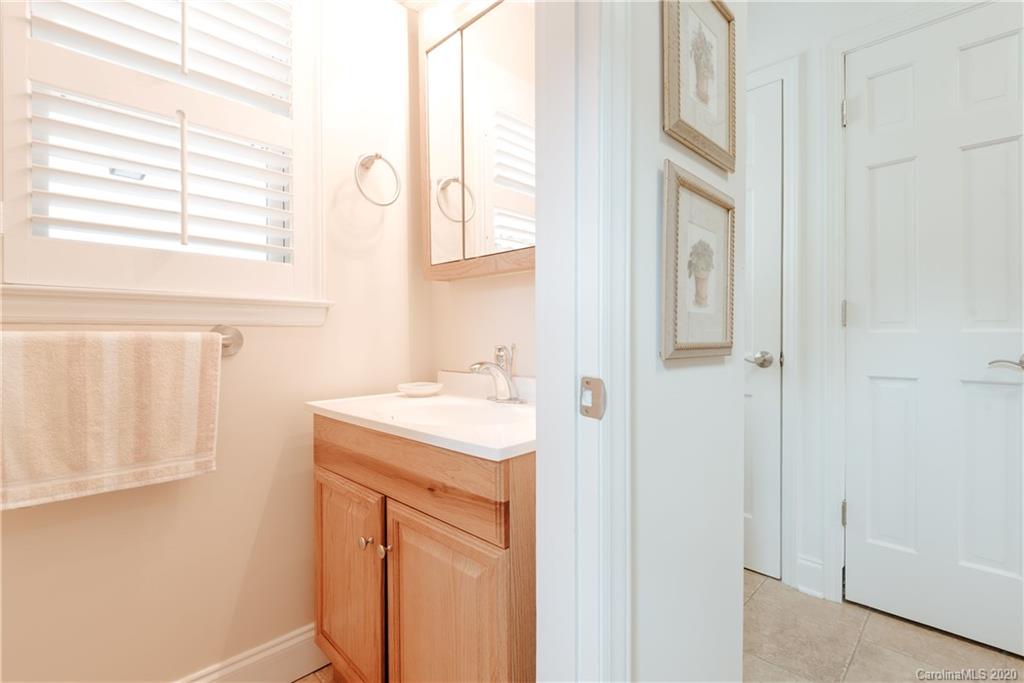 1001 Lansdowne Road Charlotte, NC 28270 - Photo 20 of 37 a bathroom with a granite countertop sink and a mirror