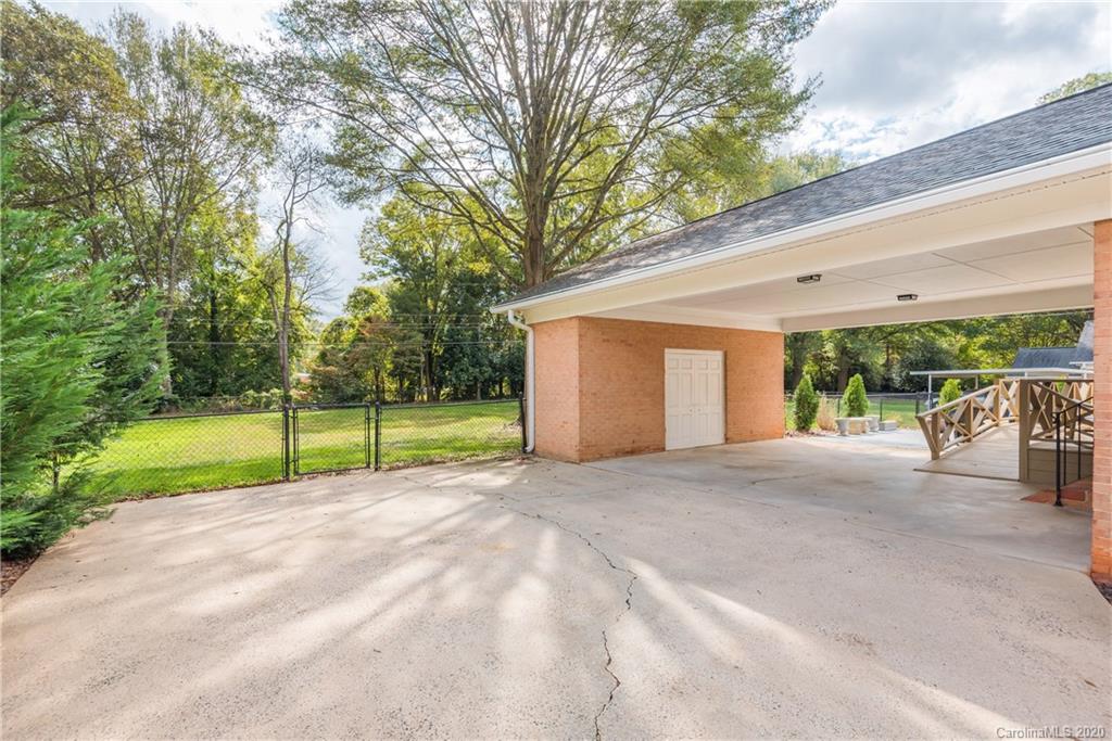 1001 Lansdowne Road Charlotte, NC 28270 - Photo 30 of 37 a view of a house with backyard and a tree