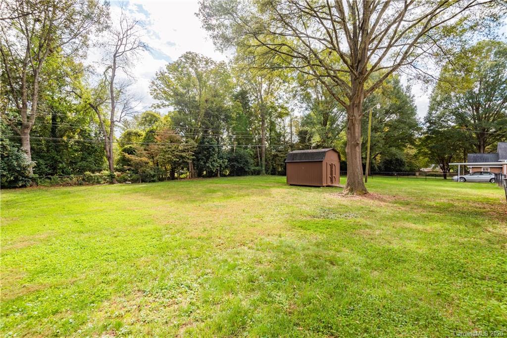 1001 Lansdowne Road Charlotte, NC 28270 - Photo 34 of 37 a backyard of a house with lots of green space