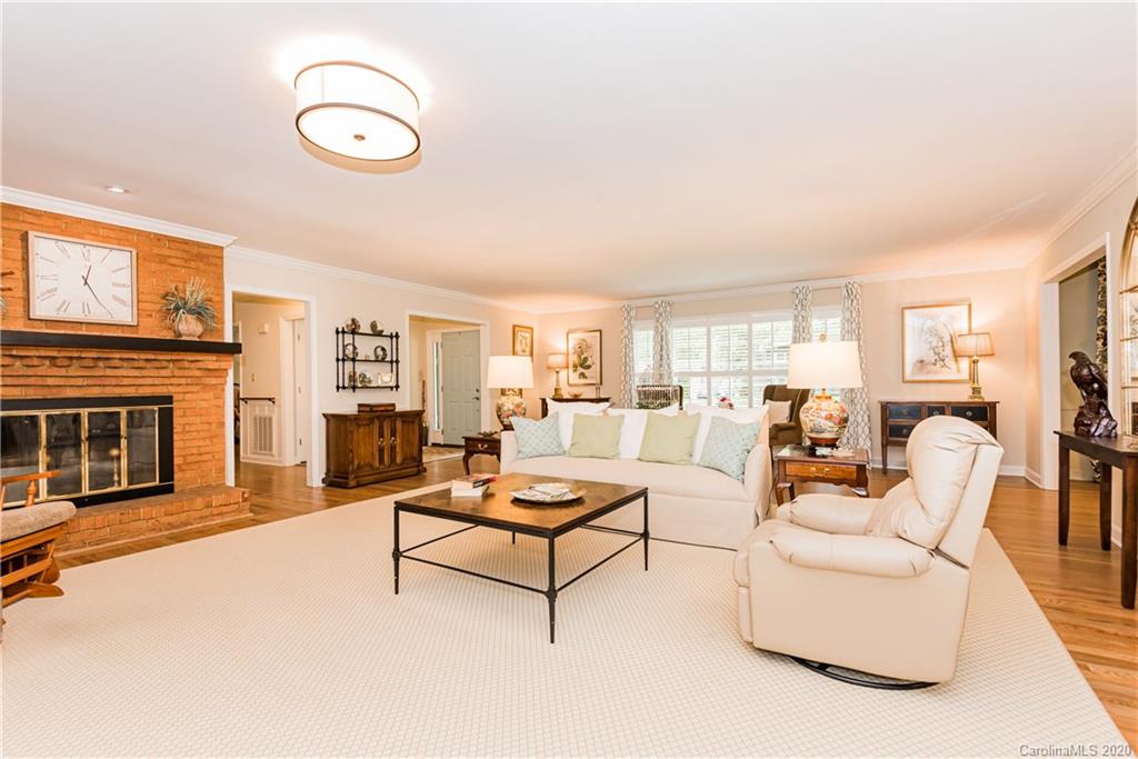 1001 Lansdowne Road Charlotte, NC 28270 - Photo 6 of 37 a living room with furniture kitchen view and a fireplace