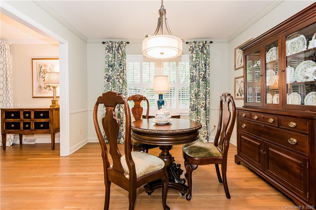 1001 Lansdowne Road Charlotte, NC 28270 - Photo 9 of 37 a view of a dining room with furniture and wooden floor
