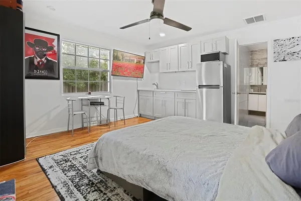 a bed room with a bed and a chair