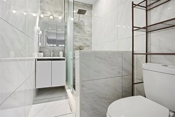 a bathroom with a toilet a sink and a shower