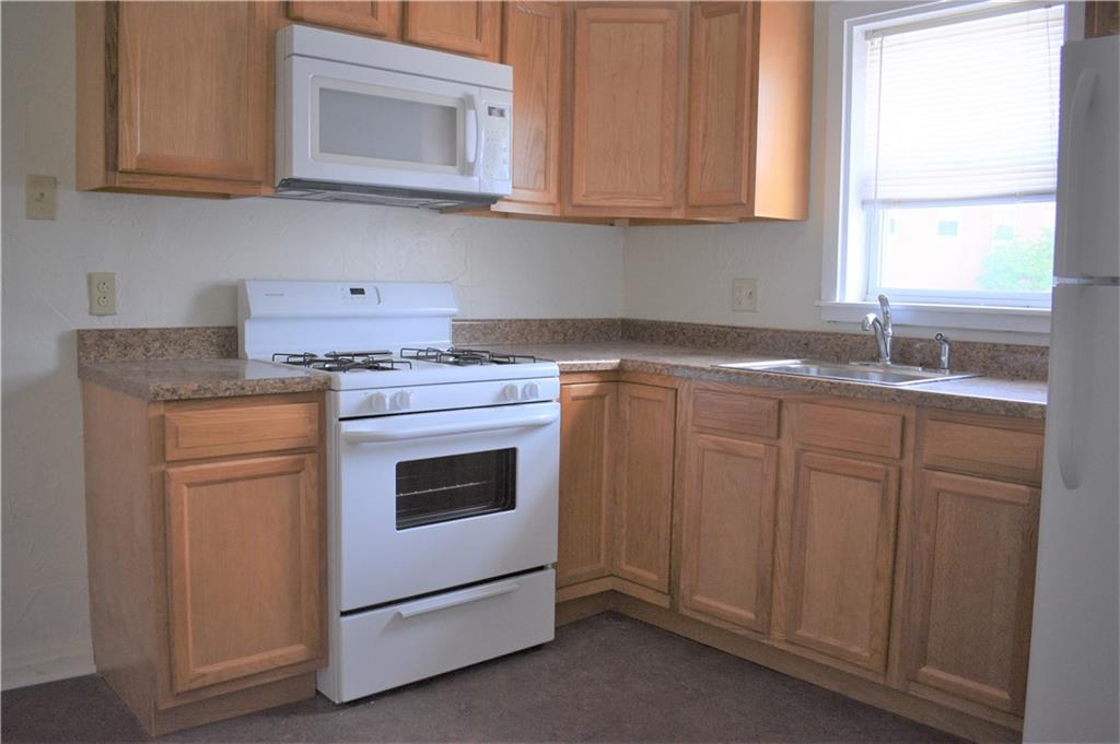 757 Locust Street Indiana, PA 15701 - Photo 18 of 19 a kitchen with cabinets appliances a sink and a window