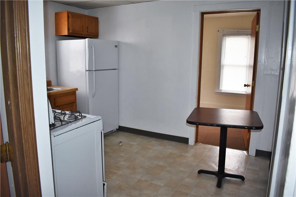 757 Locust Street Indiana, PA 15701 - Photo 5 of 19 a kitchen with a refrigerator and a table