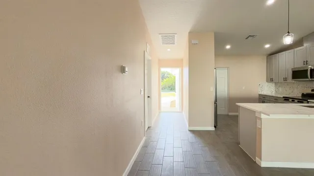 a view of a kitchen with a refrigerator and a sink