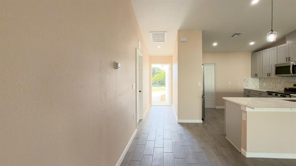 11154 Pendleton Avenue Englewood, FL 34224 - Photo 15 of 32 a view of a kitchen with a refrigerator and a sink