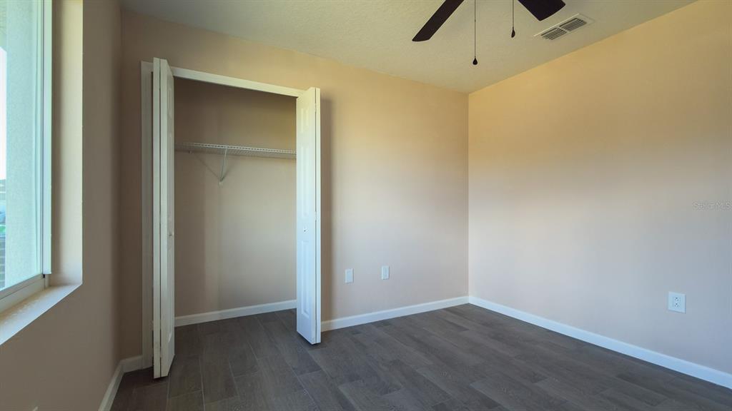 11154 Pendleton Avenue Englewood, FL 34224 - Photo 18 of 32 an empty room with wooden floor and closet