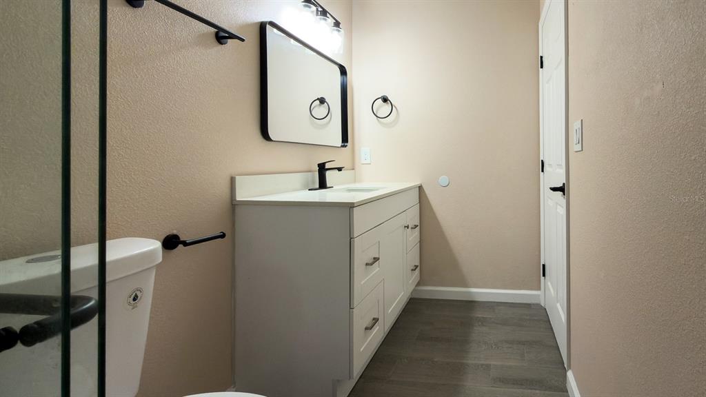 11154 Pendleton Avenue Englewood, FL 34224 - Photo 23 of 32 a bathroom with a sink and mirror