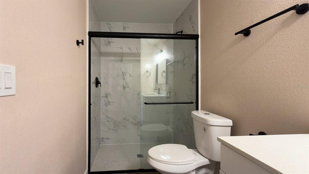 11154 Pendleton Avenue Englewood, FL 34224 - Photo 25 of 32 a white toilet sitting next to a bathroom sink