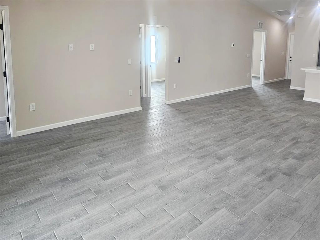 11154 Pendleton Avenue Englewood, FL 34224 - Photo 28 of 32 a view of an empty room with wooden floor