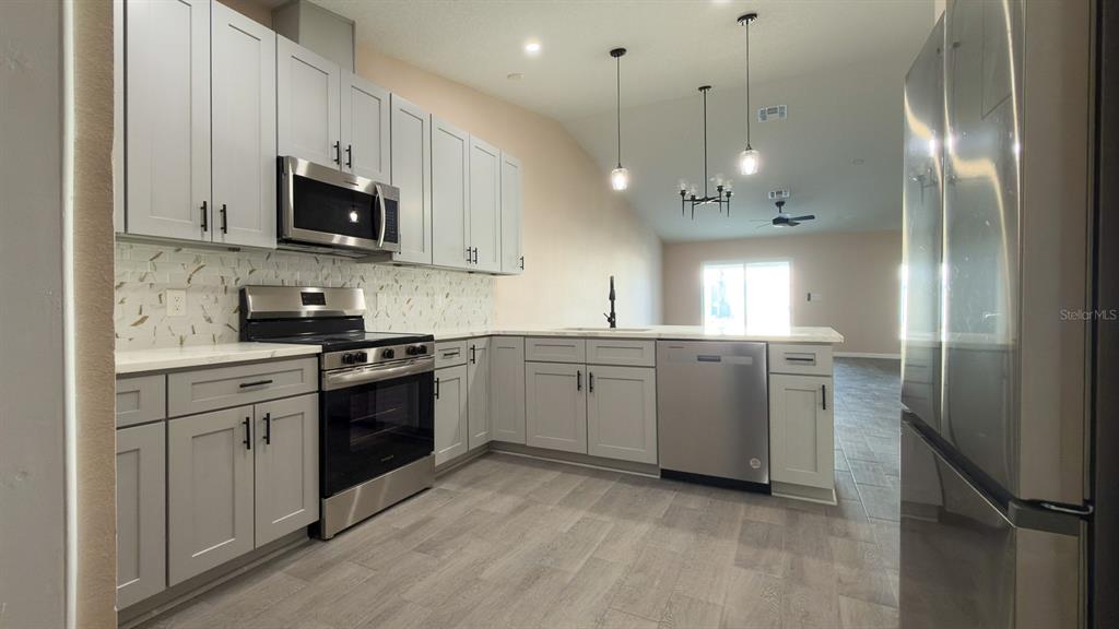 11154 Pendleton Avenue Englewood, FL 34224 - Photo 32 of 32 a kitchen with a sink stainless steel appliances and cabinets