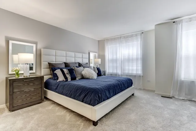 a large bedroom with a bed and window