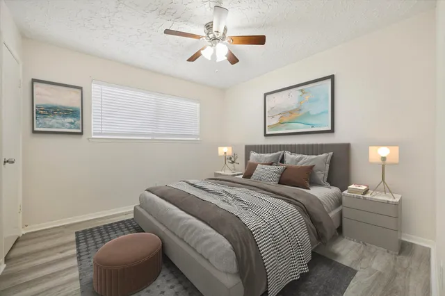 a bedroom with a bed and a painting on the wall