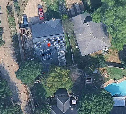 an aerial view of multiple houses with yard