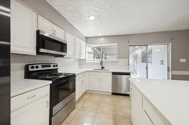 a kitchen with a sink stove and microwave