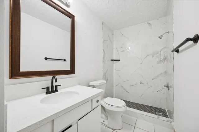 a bathroom with a sink toilet and shower