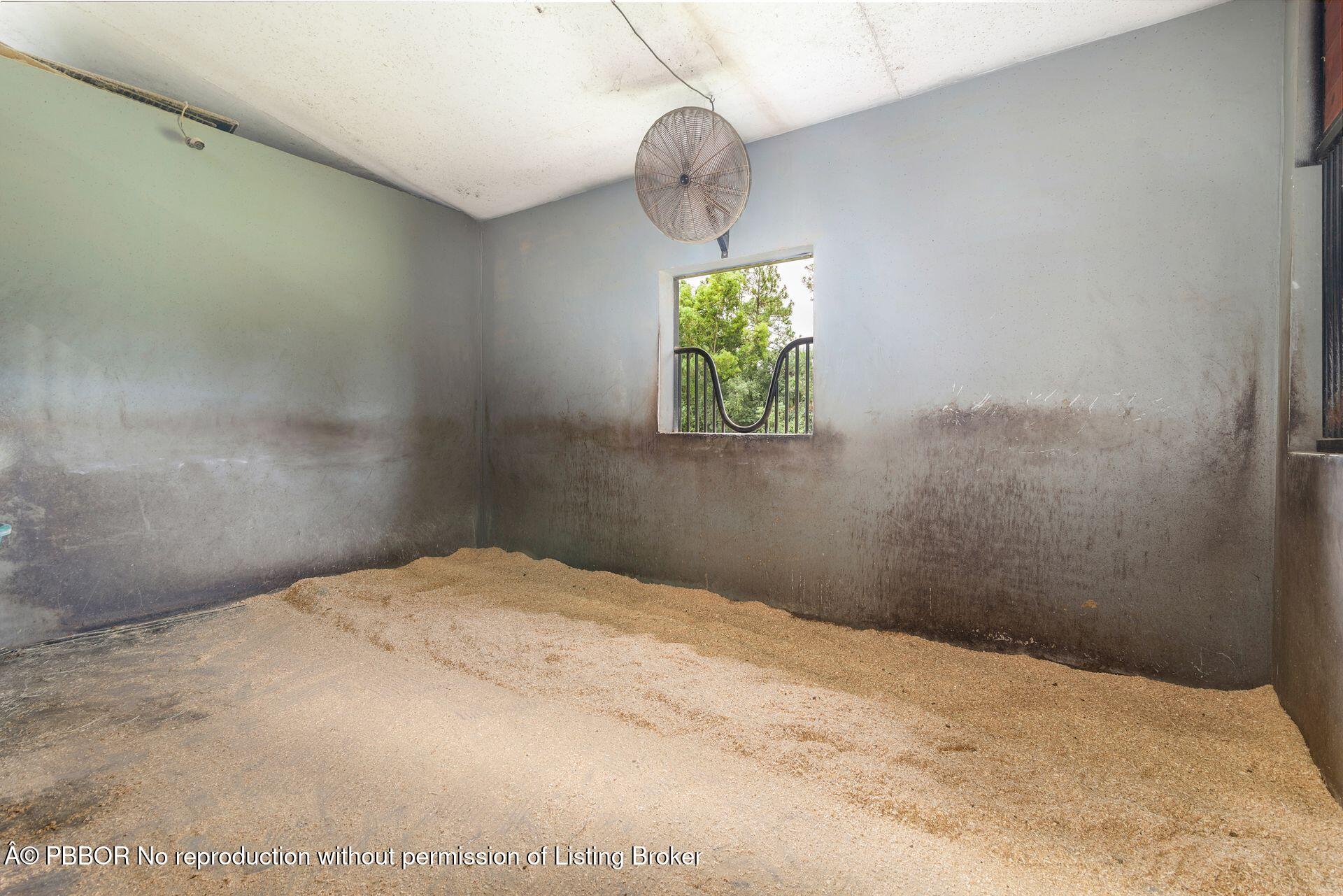 2770 E Road Loxahatchee, FL 33470 - Photo 12 of 51 a bedroom with a bed and a window