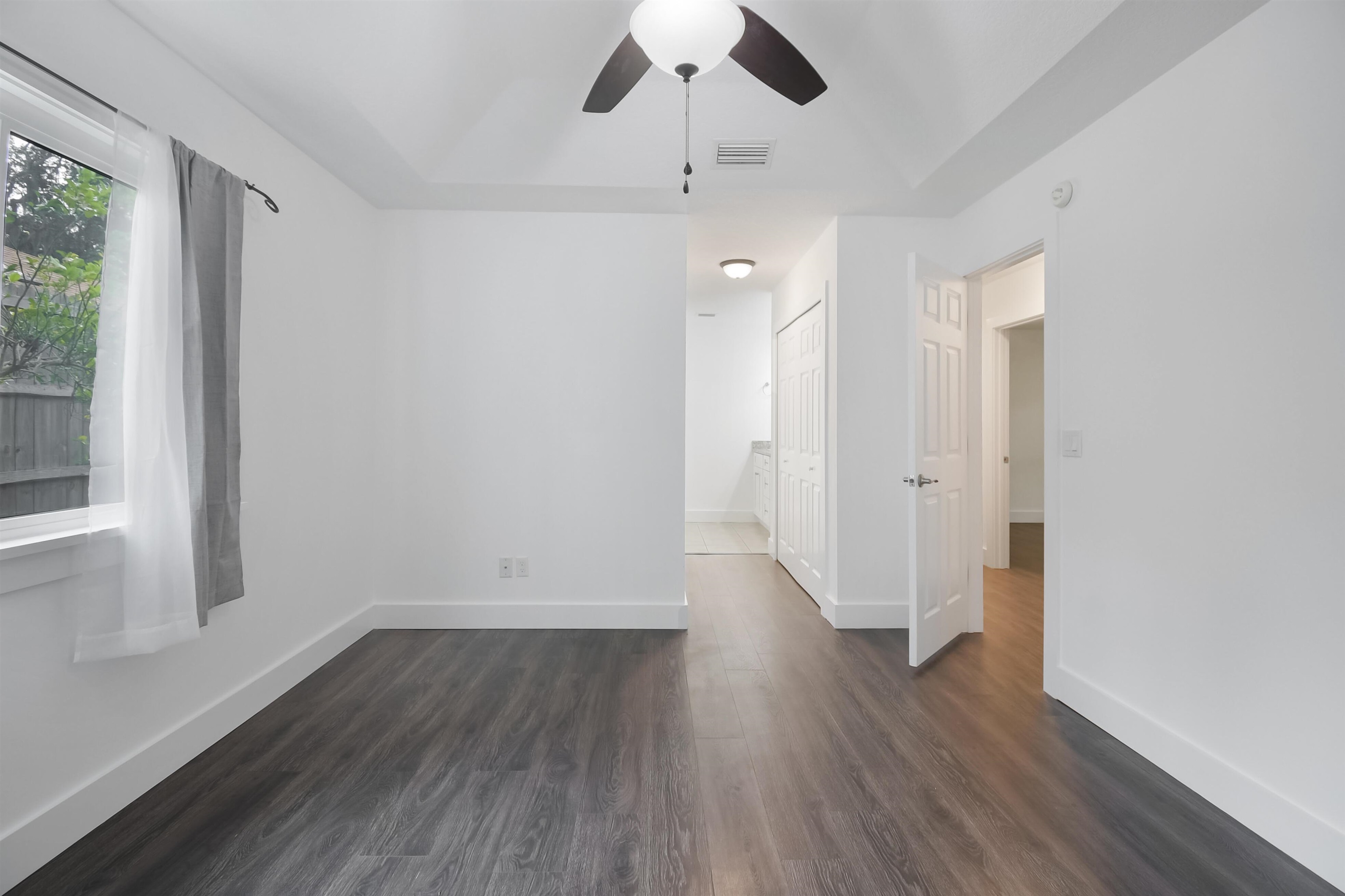 497 Pyrus Street St. Augustine, FL 32080 - Photo 11 of 36 Unfurnished room with dark wood-style floors and ceiling fan
