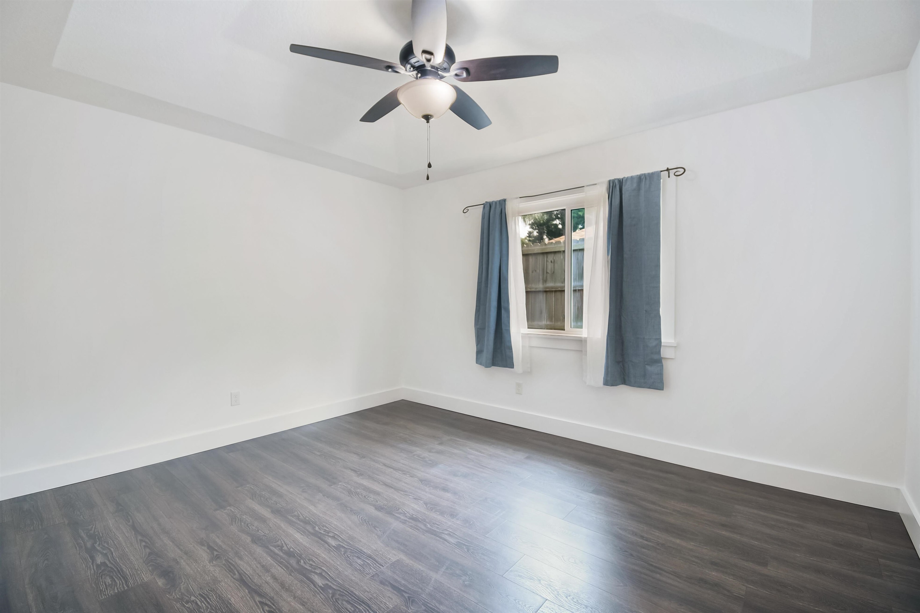 497 Pyrus Street St. Augustine, FL 32080 - Photo 12 of 36 Unfurnished room featuring dark wood-type flooring and a ceiling fan