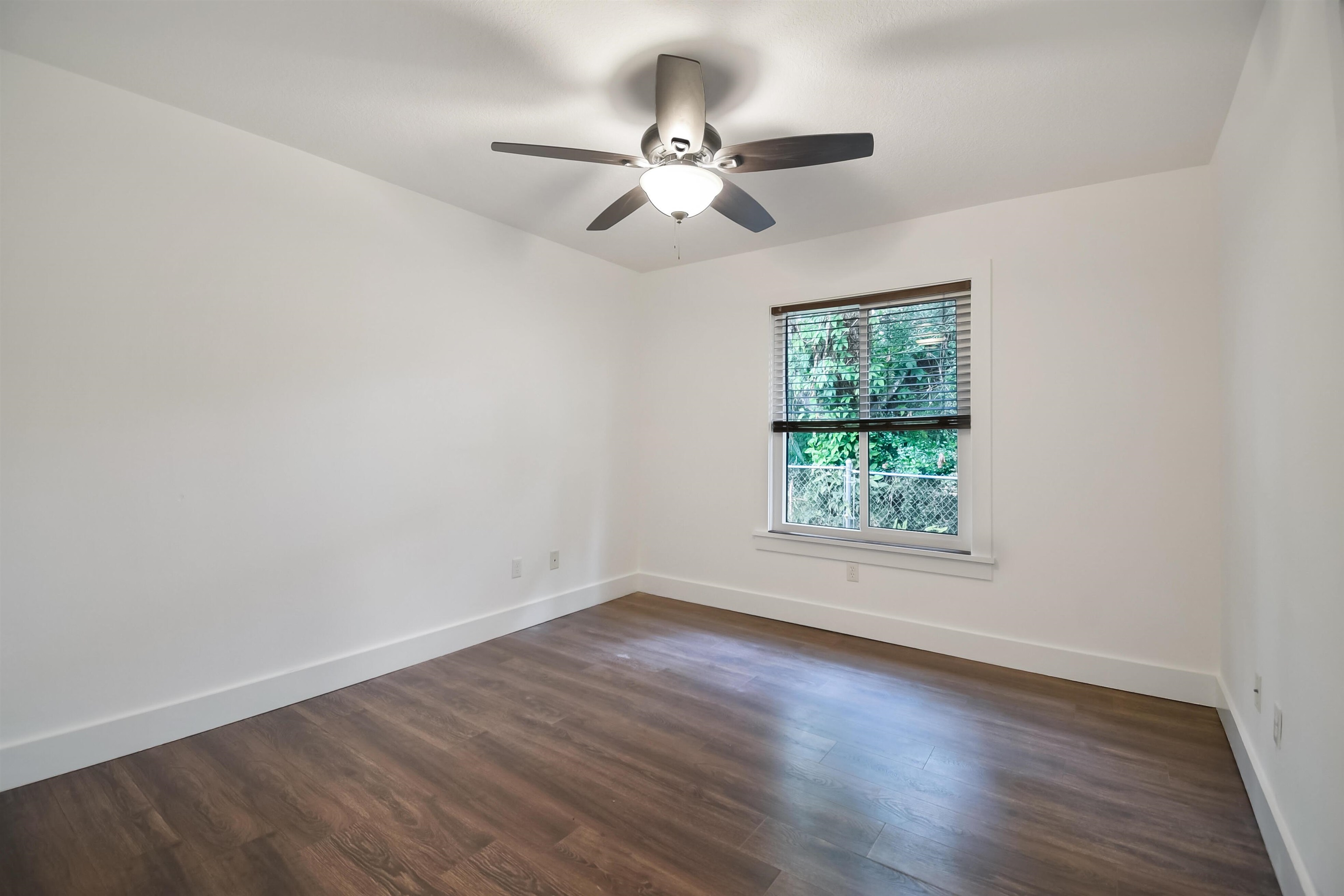 497 Pyrus Street St. Augustine, FL 32080 - Photo 18 of 36 an empty room with wooden floor chandelier fan and windows